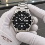 Orient FAA02001B9 held in white cotton gloves with Luxury Watches Malaysia cuff mark