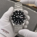 Orient FAA02004B9 held in white cotton gloves with Luxury Watches Malaysia cuff mark