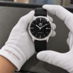 Orient FAC0000DB0 held in white cotton gloves with Luxury Watches Malaysia cuff mark