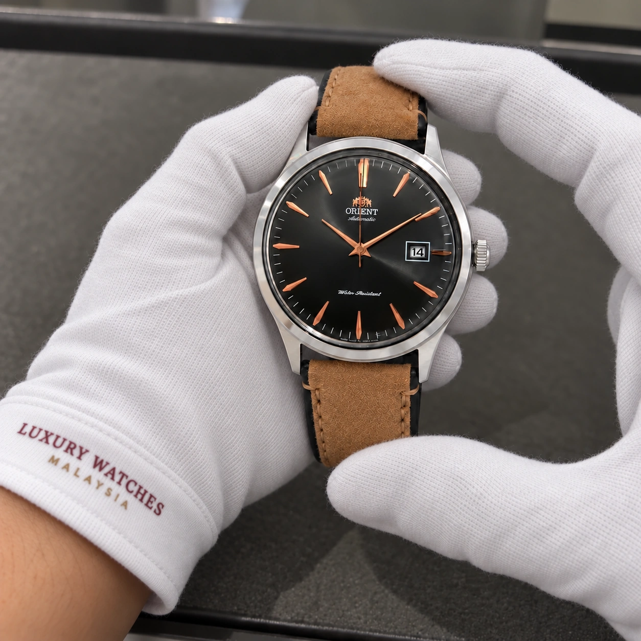 Orient FAC08003A0 presented in white gloves with a Luxury Watches Malaysia cuff mark