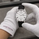 Citizen NH8350-08A held in white cotton gloves with Luxury Watches Malaysia cuff mark