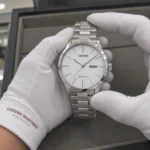 Citizen NH8350-83A held in white cotton gloves with Luxury Watches Malaysia cuff mark