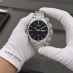 Citizen NH8350-83E held in white cotton gloves with Luxury Watches Malaysia cuff mark