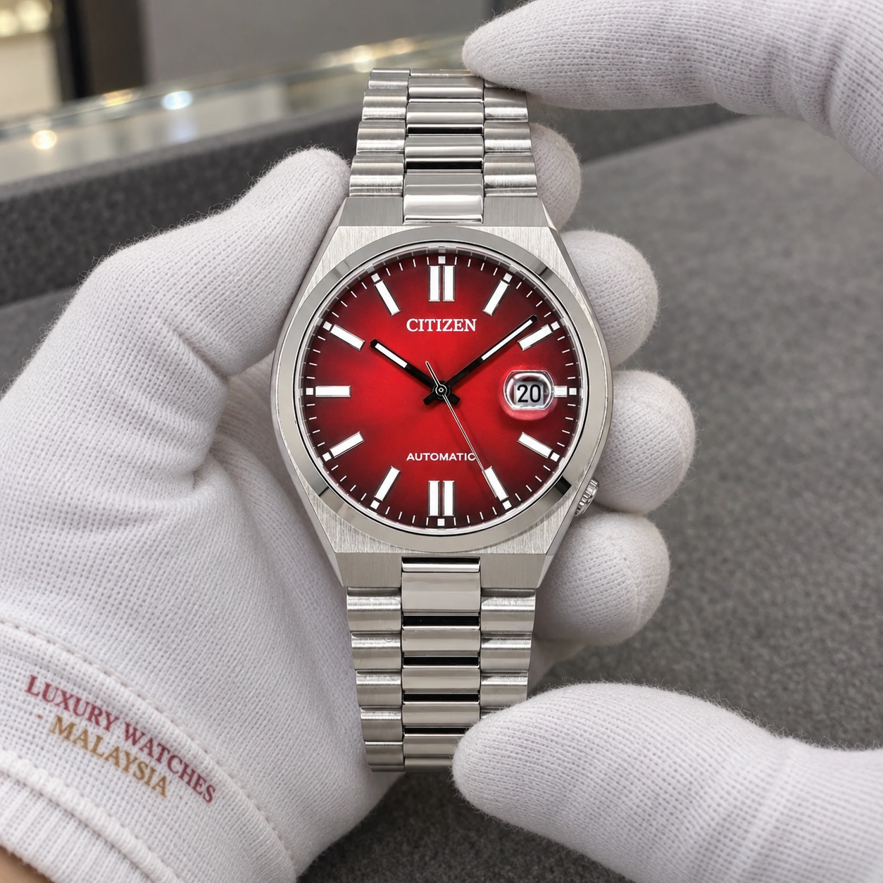 Citizen NJ0150-56W presented in cotton gloves
