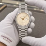 Citizen NJ0151-88W held in white cotton gloves with Luxury Watches Malaysia cuff mark