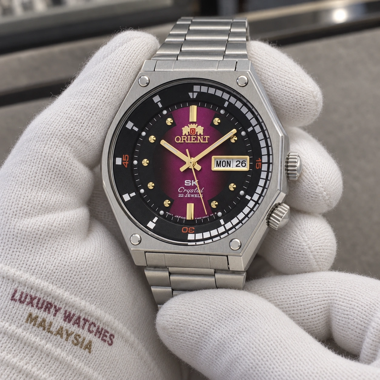 Orient RA-AA0B02R19B presented in cotton gloves