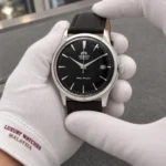 Orient RA-AC0M02B10B held in white cotton gloves with Luxury Watches Malaysia cuff mark