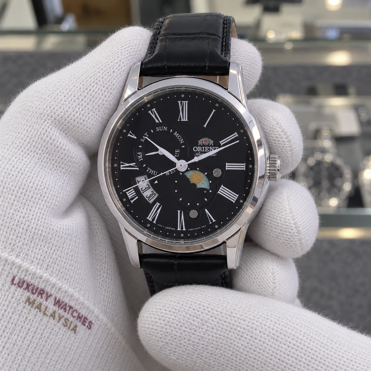 Orient RA-AK0010B10B presented in cotton gloves