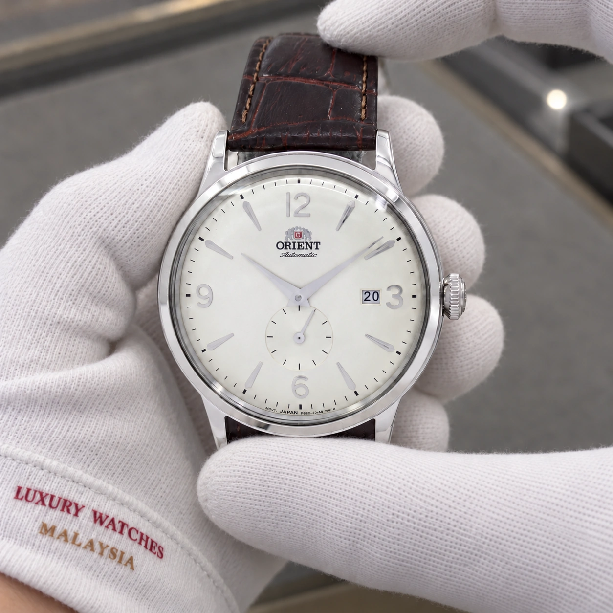 Orient RA-AP0003S10B presented in cotton gloves