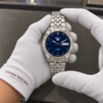 Seiko SNK357K1 held in white cotton gloves with Luxury Watches Malaysia cuff mark