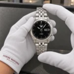 Seiko SNK361K1 held in white cotton gloves with Luxury Watches Malaysia cuff mark