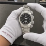 Seiko SNK623K1 held in white cotton gloves with Luxury Watches Malaysia cuff mark