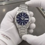 Seiko SNKD99K1 held in white cotton gloves with Luxury Watches Malaysia cuff mark