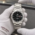 Seiko SNKE01K1 held in white cotton gloves with Luxury Watches Malaysia cuff mark
