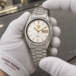 Seiko SNXG47K1 held in white cotton gloves with Luxury Watches Malaysia cuff mark