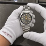 Seiko SNXS75K1 held in white cotton gloves with Luxury Watches Malaysia cuff mark