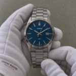 Casio MTP-VD03D-2A2 blue dial watch in white gloves under subdued room lighting — illustrative image