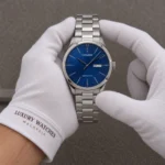 Citizen Automatic NH8350-83L Men's Watch presented by cotton-gloved hands with wrist-cuff branding