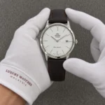 Orient 2nd Generation Bambino Version 3 Classic Automatic FAC0000EW0 TAC0000EW0 Men's Watch presented by cotton-gloved hands with wrist-cuff branding