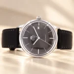 Orient Bambino FAC0000CA0 grey dial, date window and mineral crystal, horizontal studio view